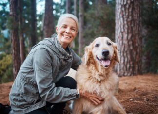 Shot of a senior woman out for a hike with her dog