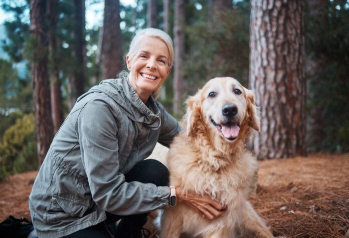 Shot of a senior woman out for a hike with her dog Shot of a senior woman out for a hike with her dog